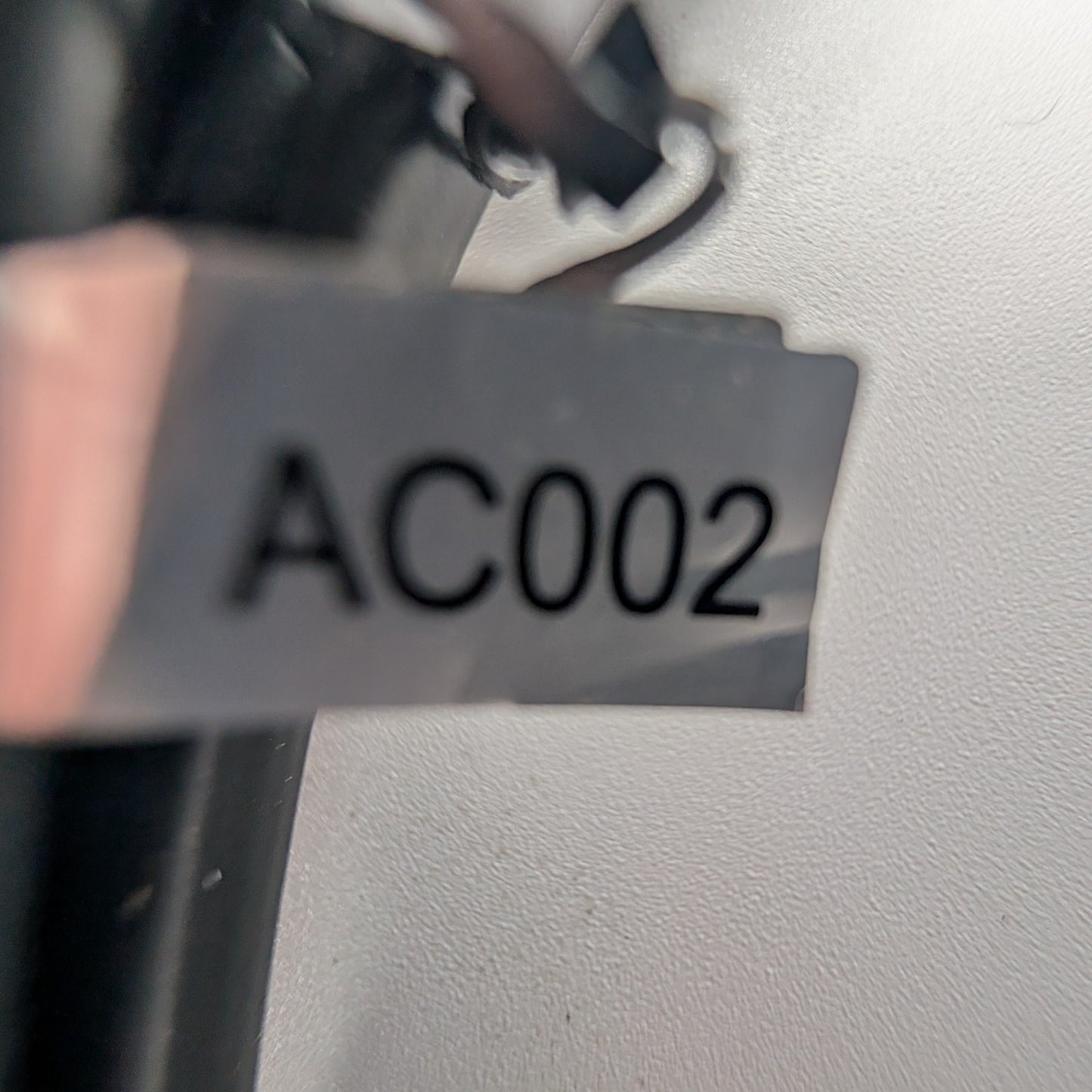label found near wall plug. Says: AC002