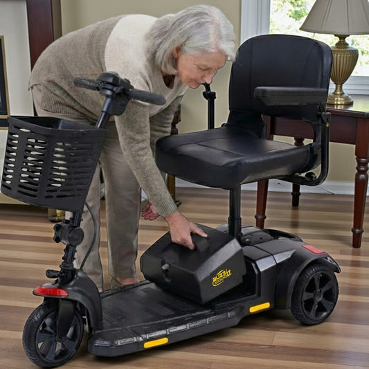 woman installing battery box mbe-0003 into a buzzaround LT 3 wheel scooter