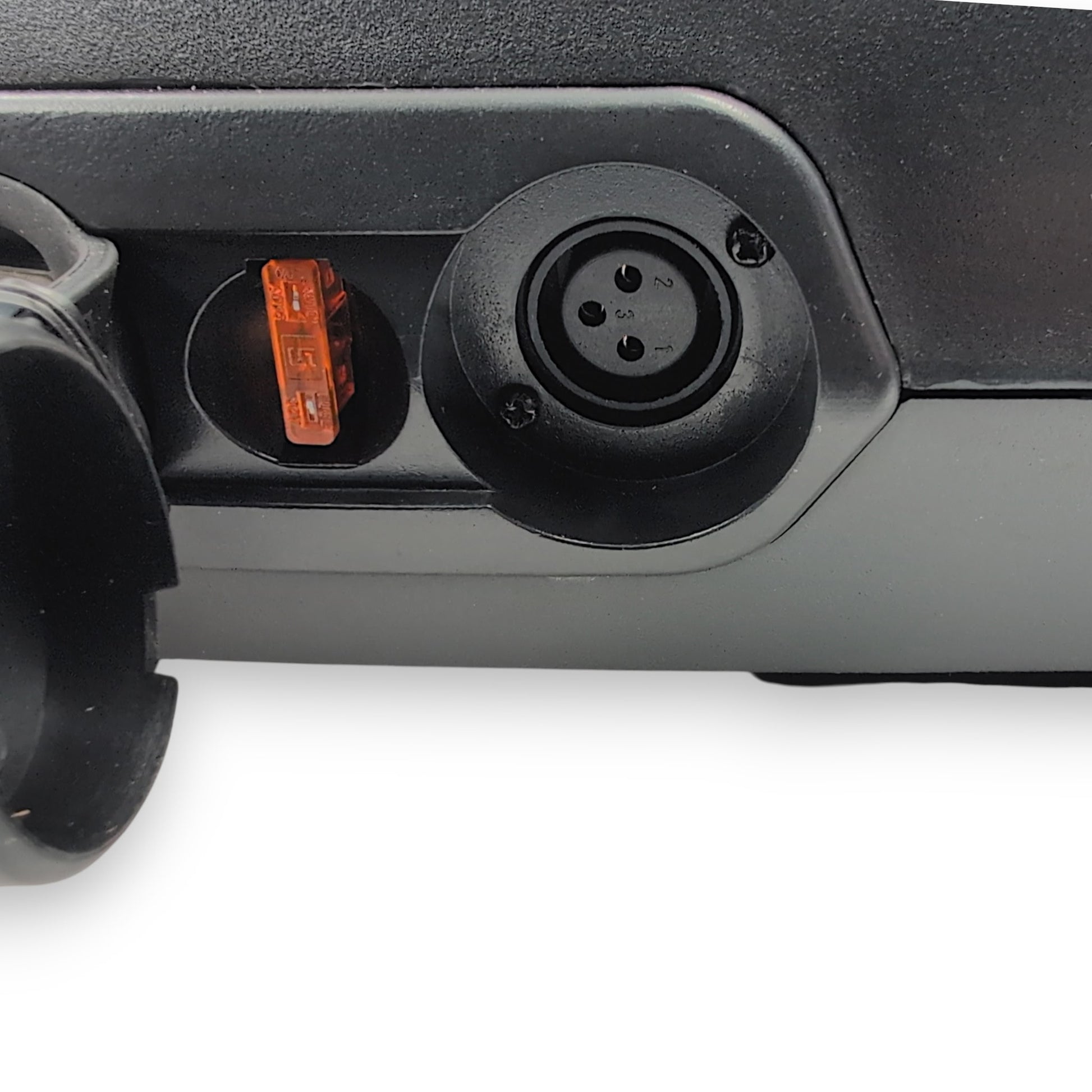 connector cover in an open state showing the 5 amp fuse and 3 pin female xlr connector for charging