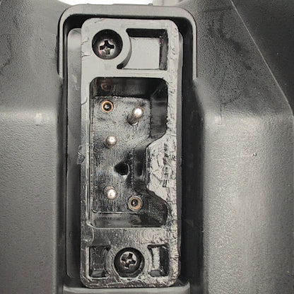 Closeup o the 3-pin port on the bottom of the battery box. used to connect the battery box to the scooter
