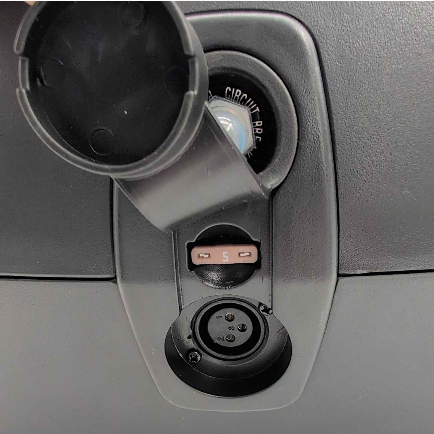 charger port cover removed, showing: 3 pin, xlr, charger port, 5 amp fuse, and 20 amp circuit breaker reset button