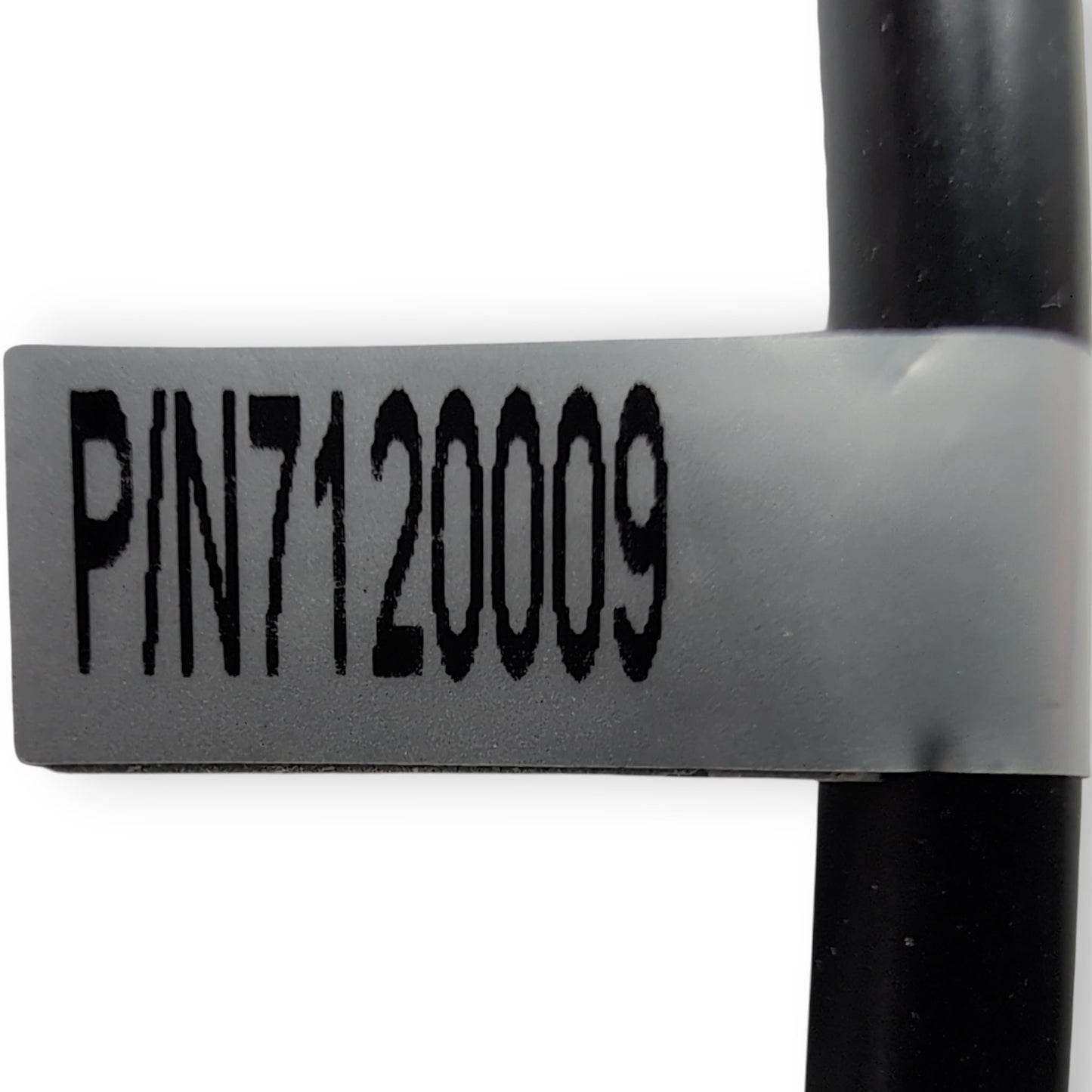 label found on cord near connector. States: part Number: 7120009